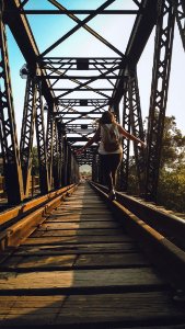 Woman Walking On A Train Rail photo