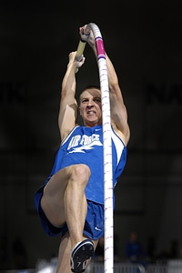 Athletic man vaulting photo