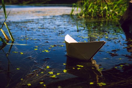 Photo Of White Paper Boat On Body Of Water photo