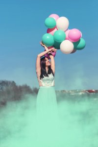 Woman Wearing Green Dress Holding Balloons photo