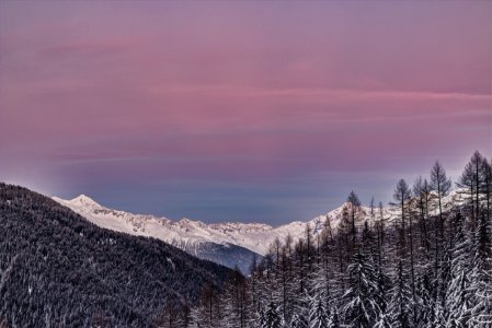 Photo Of Mountains Covered With Snow And Surrounded With Trees photo