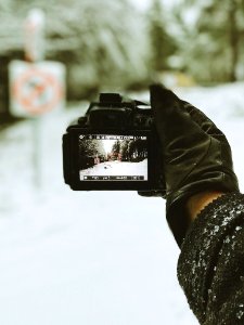 Close-up Photo Of Person Holding Black Camera photo