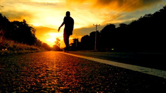 Silhouette Photo Of Man Riding Skateboard photo