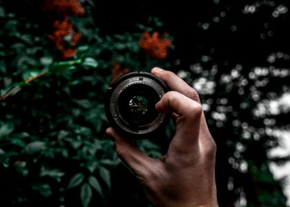 Person Holding Camera Lens photo