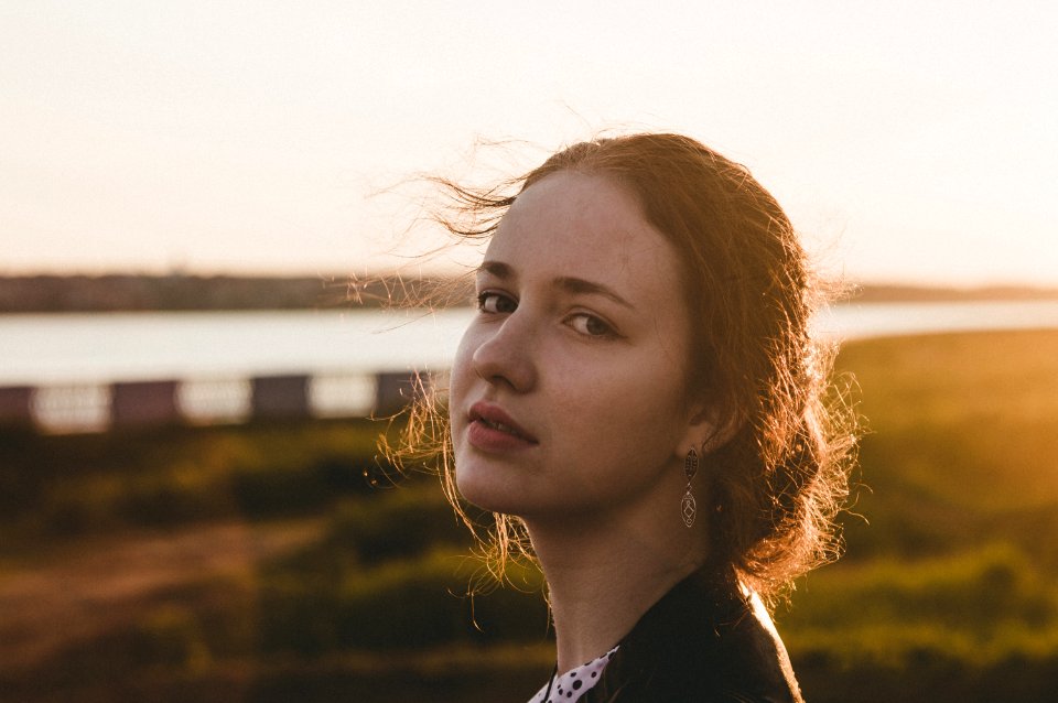 Tilt Shift Lens Photography Of Woman During Sunset