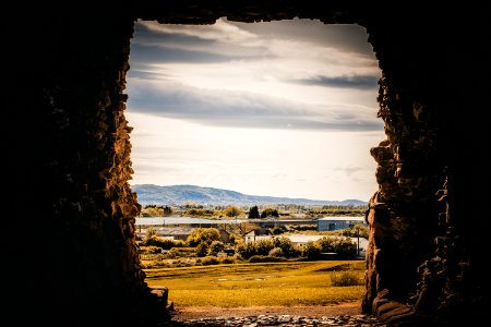 Rock Formation With Grassfield Background