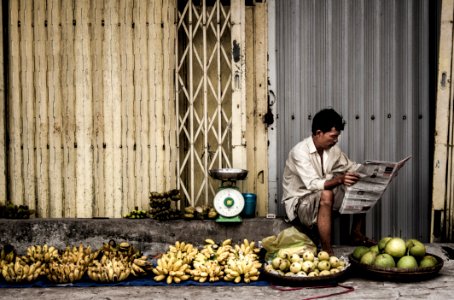 Man Sitting Near Fruits photo
