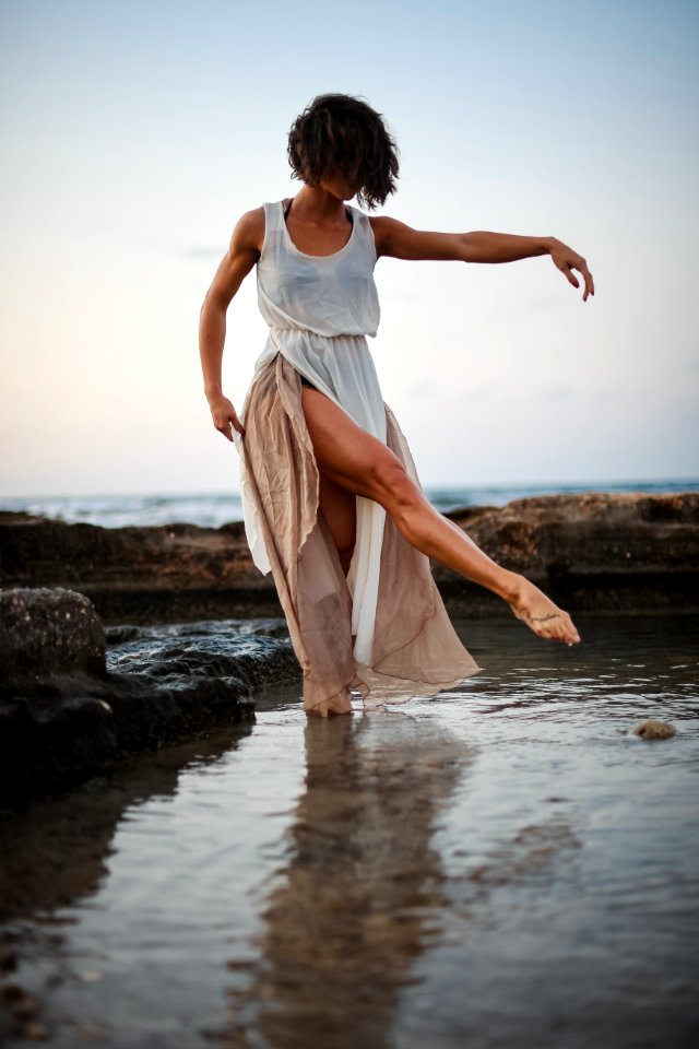 Woman Wearing White Tank Dress Posing In Body Of Water