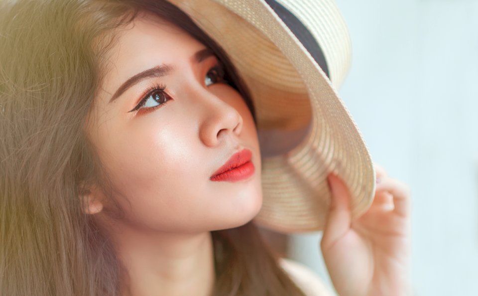 Woman Holding White Hat photo