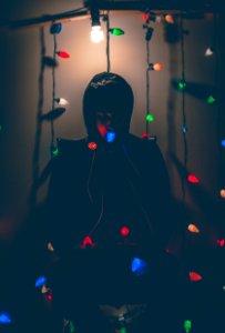 Man Sitting On Chair With Multi-colored String Lights photo