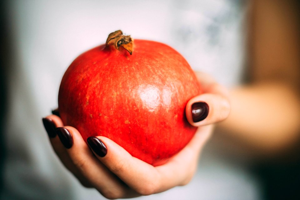 Red Pomegranate At Womans Hand