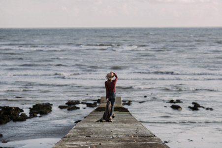 Person Standing On Dock Holding Textile