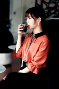 Woman In Pink And Black Dress Drinking Cola