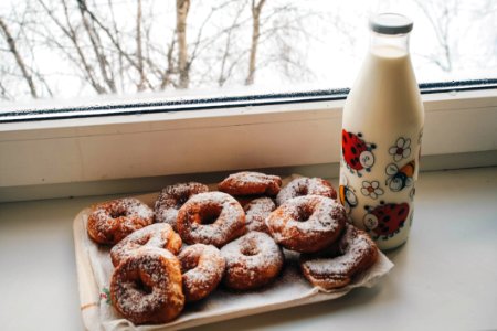 Doughnuts And Milk Bottle Near Clear Glass Window photo