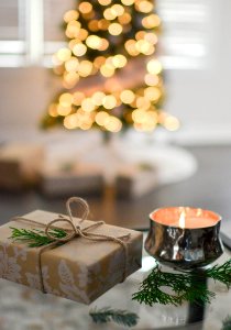 Close-Up Photography Of Gift Besides Candle photo