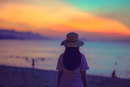 Woman In White Dress Standing Near Beach During Sunset photo