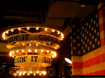 Round Beige Wooden Chandelier Near Flag Of The Usa