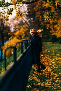 Woman Wearing Black Coat Near Railings photo