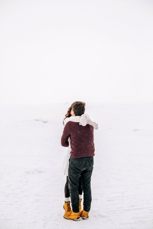 Man And Woman Kissing On Snow Field