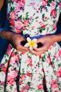 Woman In White And Green Floral Dress Holding Flower