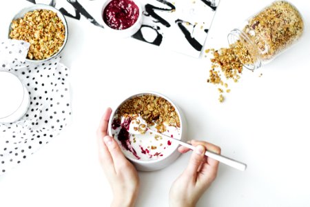 Person Mixing Cereal Milk And Strawberry Jam On White Ceramic Bowl photo