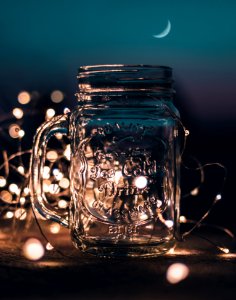 Shallow Focus Photograph Of Clear Glass Mason Jar With Fairy Lights photo