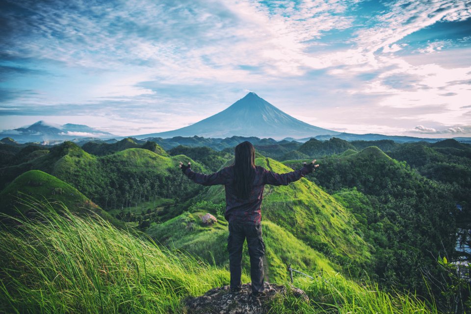 Person Standing On Top Of Hill