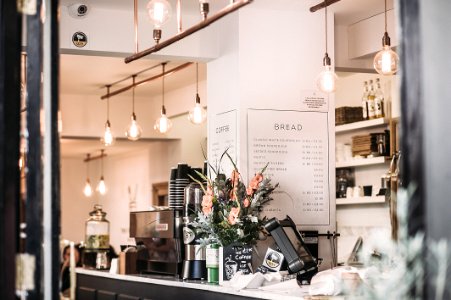 Inside The Restaurant With Pendant Lamps And Flowers photo