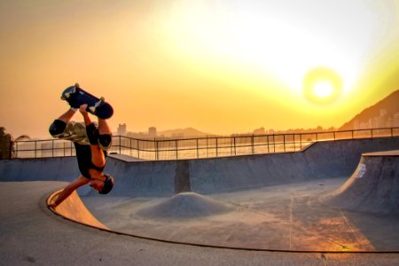 Man In Black Tank Top Skateboarding Wearing Helmet photo