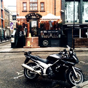 Black And White Yamah Sport Bike Parked Outside Belts Store Facade