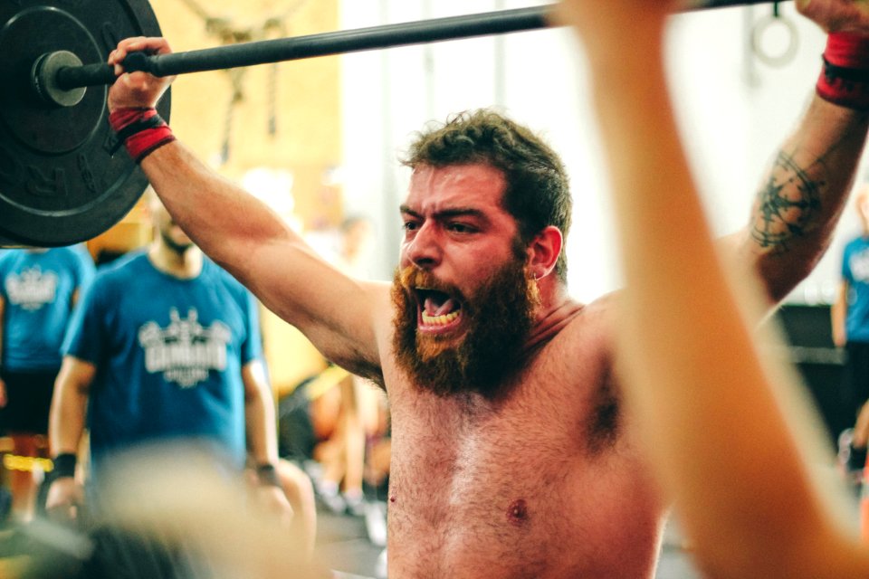 Man Carrying Black Barbell photo