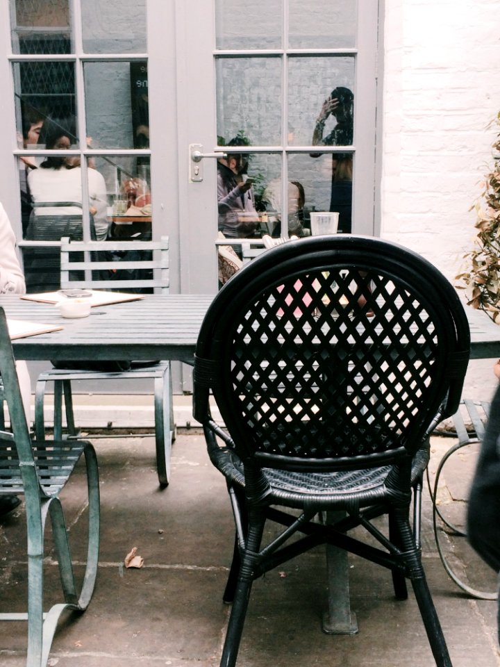 Black Metal Chair Beside Table At Daytime