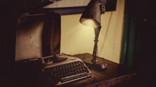 Sephia Photography Of Desk Lamp Lightened The Gray Typewriter On Wooden Table photo