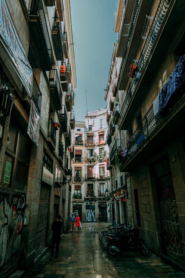 Low Angle Shot Of Two People Walking On Alley photo