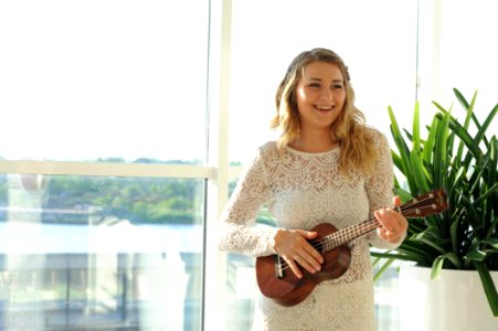 Woman Wearing White Floral Dress Playing Ukulele