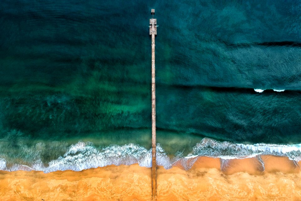 Aerial Shot Of Gray Dock On Body Of Water