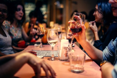 People Drinking Liquor And Talking On Dining Table Close-up Photo photo