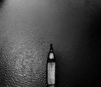 Aerial View Black Wooden Row Boat On Body Of Water photo