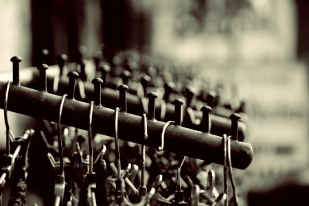 Grayscale Photography Of Hangers On Rack photo