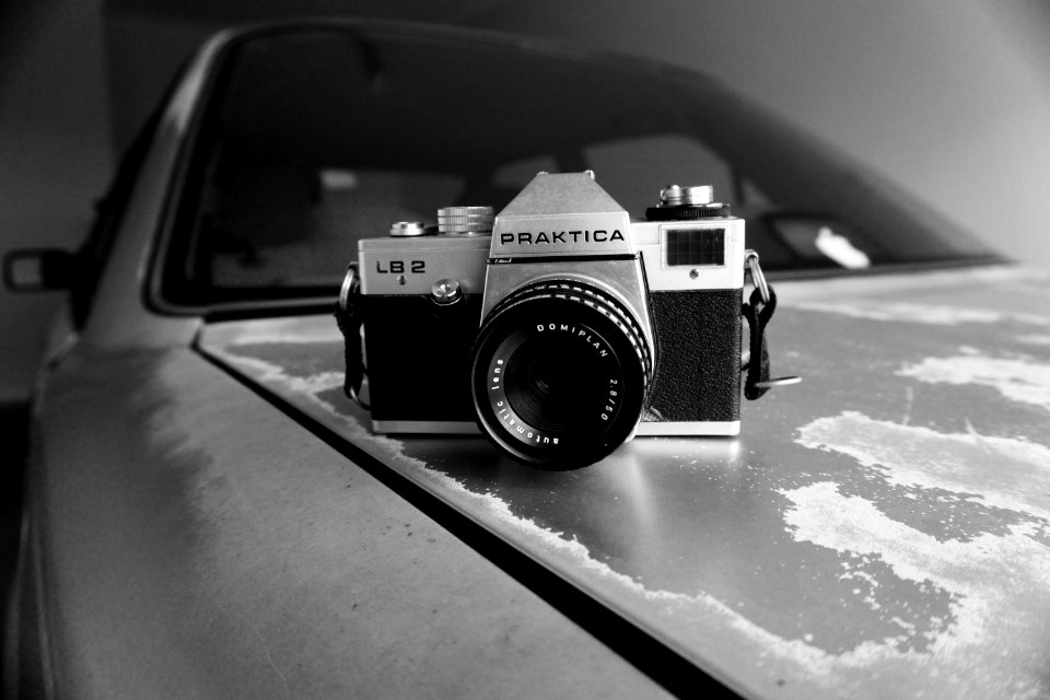 Gray Scale Photography Of Silver And Black Praktica Dslr Camera