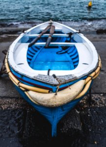 White And Blue Wooden Boat On Seashore photo