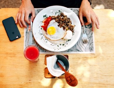 Fried Egg With Plain Rice On White Plate Beside Stainless Steel Fork With Clear Drinking Glass On Top Table photo