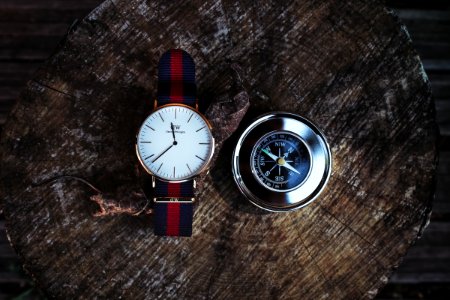 Round Silver-colored Analog Watch Beside Compass photo