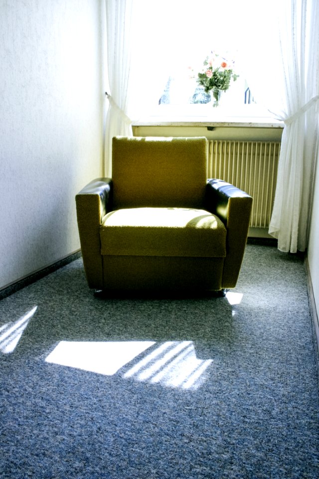 Beige Fabric Sofa Near White Window With Bundle Of Flower During Daytime