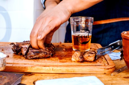 Person Slicing Grilled Meat