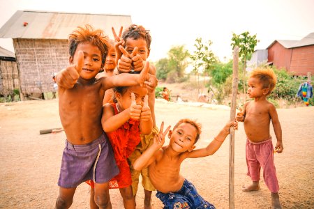 Six Boys Standing Near Trees And Houses Photo Taken photo