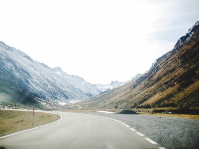 Gray Concrete Road Surrounded With Mountains photo