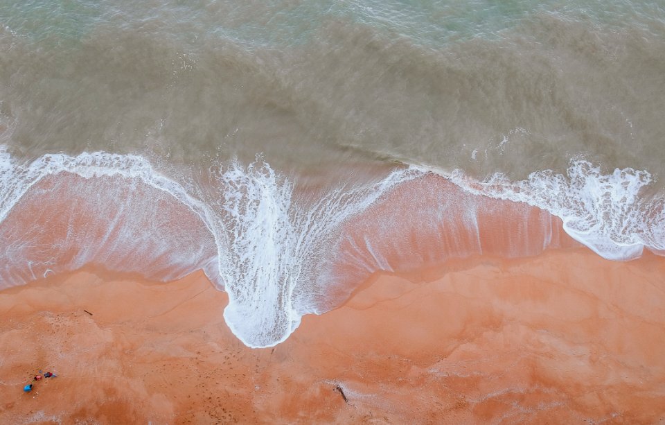 Calm Body Of Water Beside Sand photo