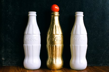 Three White And Brass Coca-cola Bottles photo