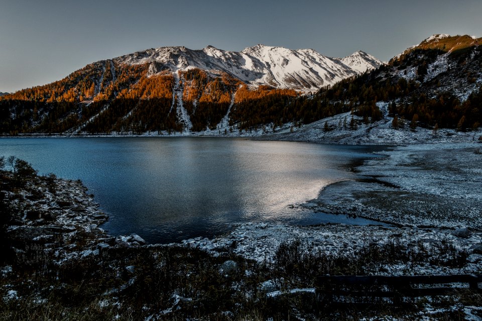 Brown And White High Rise Mountain Beside Of Body Of Water